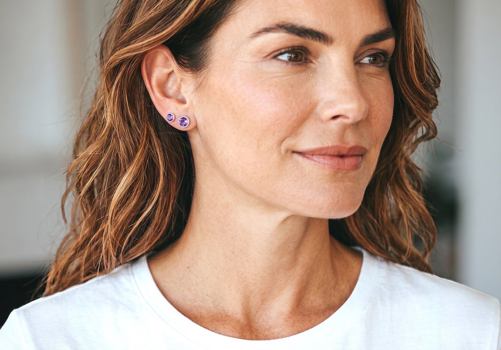 Blue Dragonfly Creations handmade round rose cut amethyst stud earrings in sterling silver worn by a woman