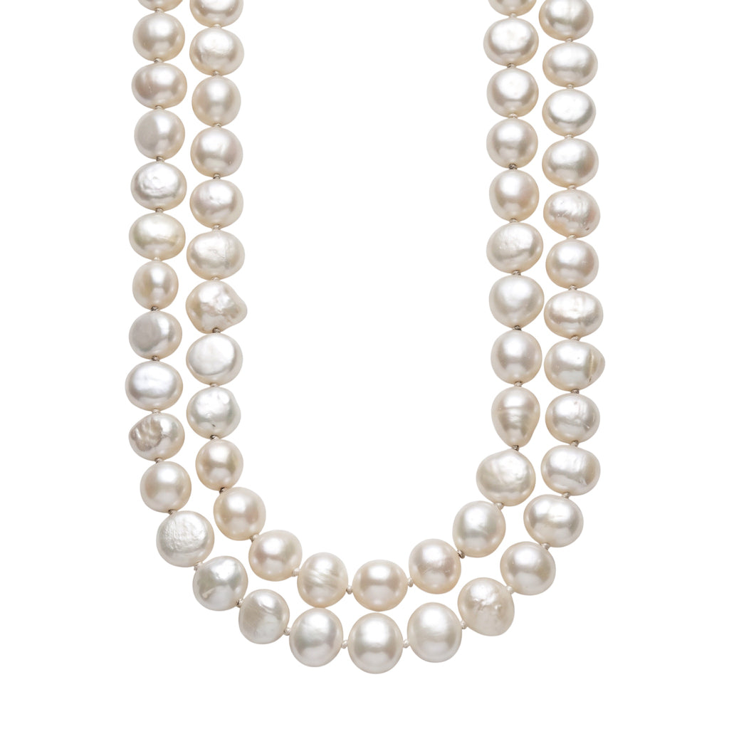 Blue Dragonfly Creations long white baroque freshwater pearl necklace with hand-knotted detailing between each pearl.