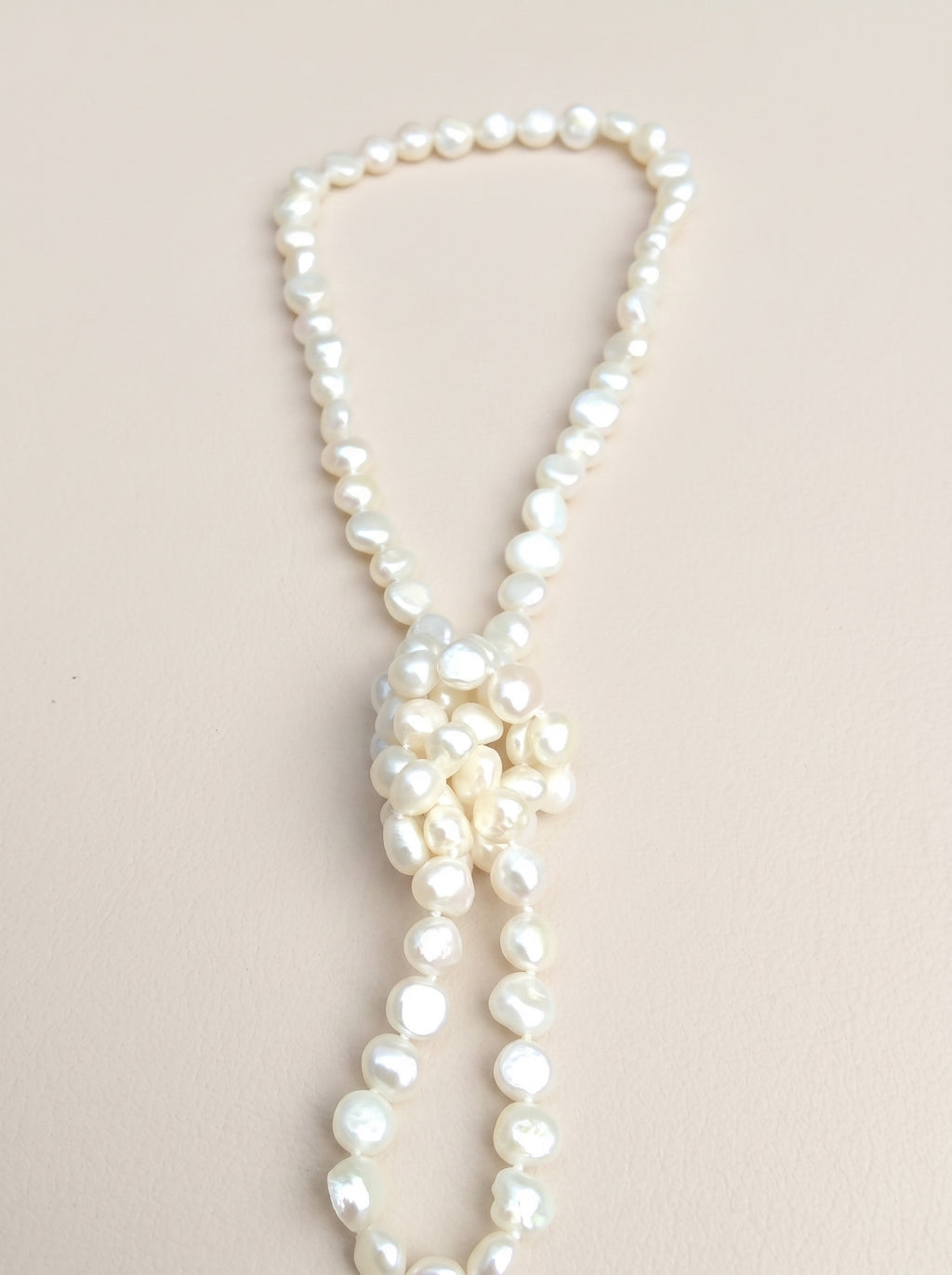 Blue Dragonfly Creations hand-knotted white baroque freshwater pearl necklace with a decorative knot detail