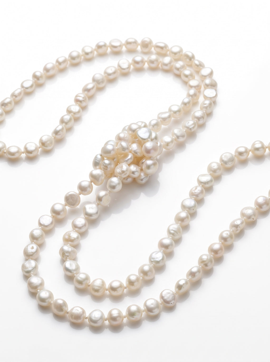 Blue Dragonfly Creations long white baroque freshwater pearl necklace with hand-knotted detailing on white background