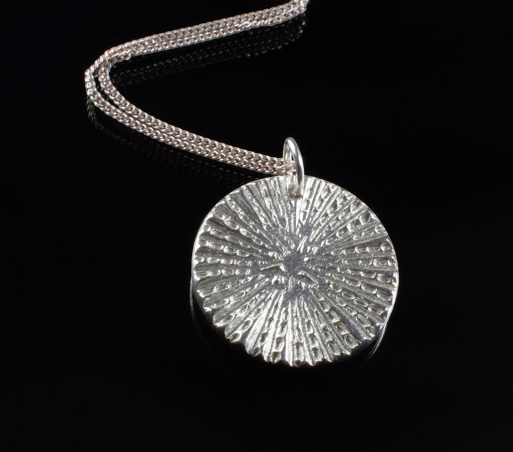 Blue Dragonfly Creations fine silver round pendant necklace with a textured sunburst pattern on a sterling silver chain