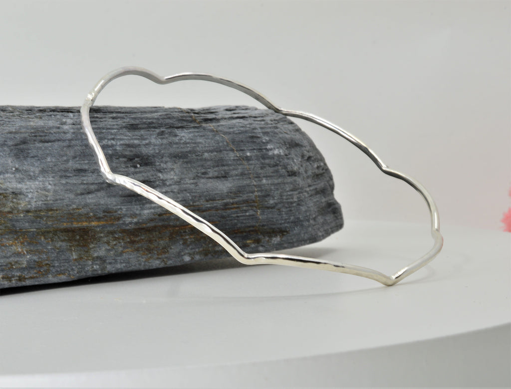 Blue Dragonfly Creations handmade sterling silver bangle with a hammered wave texture and polished finish.