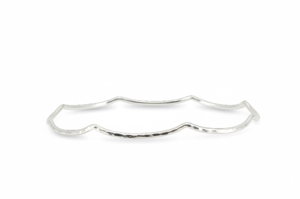 Blue Dragonfly Creations handmade sterling silver bangle with a delicate hammered wave texture and polished finish.