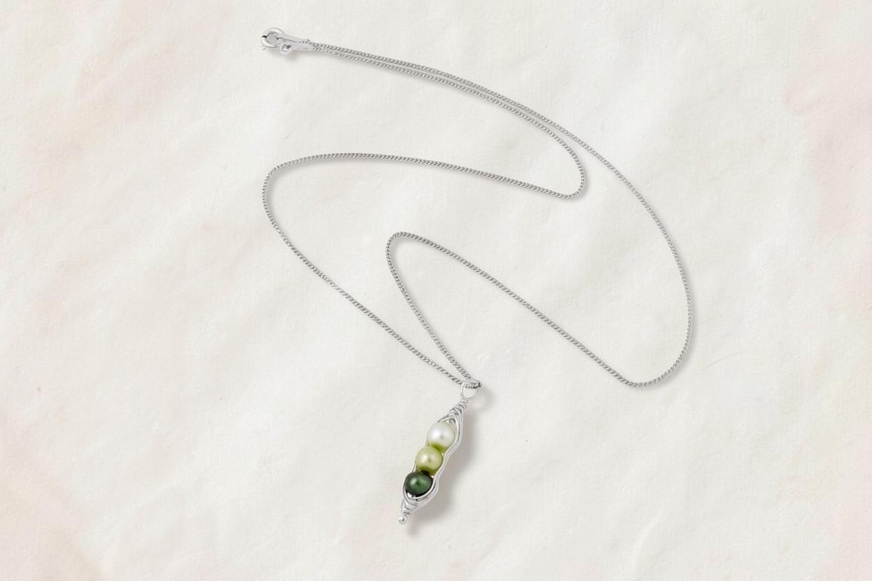 Blue Dragonfly Creations sterling silver pea pod necklace with three green freshwater pearls in a wire-wrapped pod.