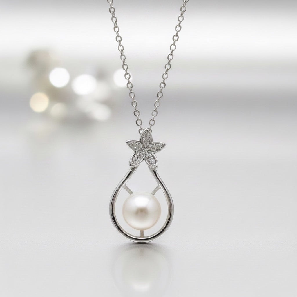 Blue Dragonfly Creations sterling silver pendant necklace with a white freshwater pearl and crystal flower detail.