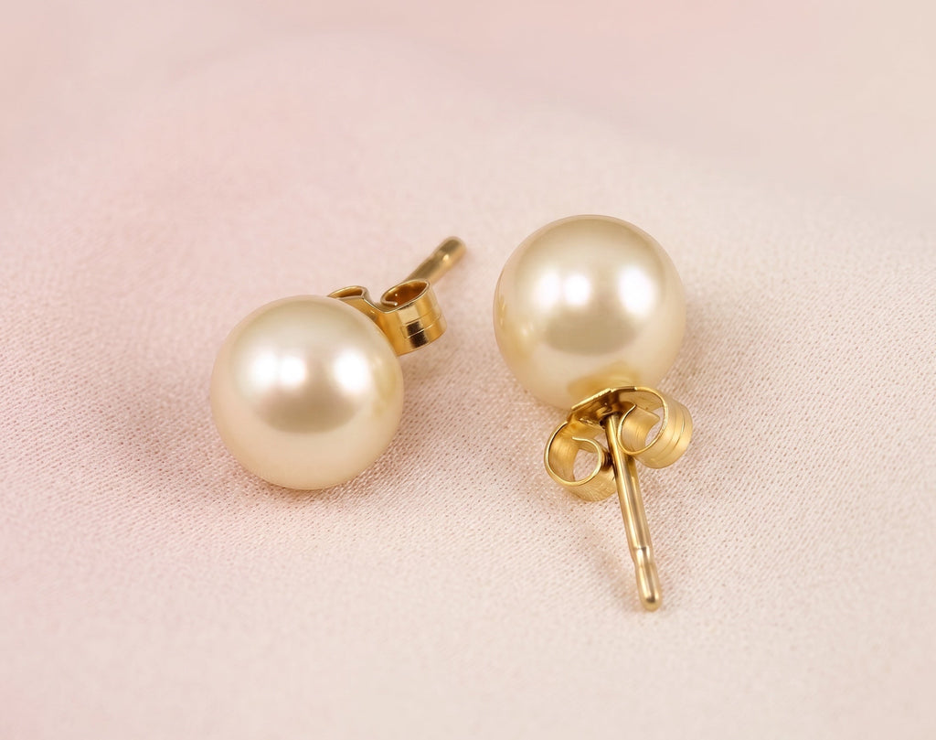 Blue Dragonfly Creations round white freshwater pearl stud earrings set in yellow gold with butterfly backs.