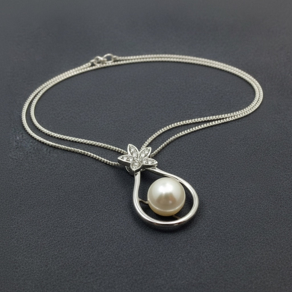 Blue Dragonfly Creations sterling silver pendant necklace with a white freshwater pearl and crystal flower detail.