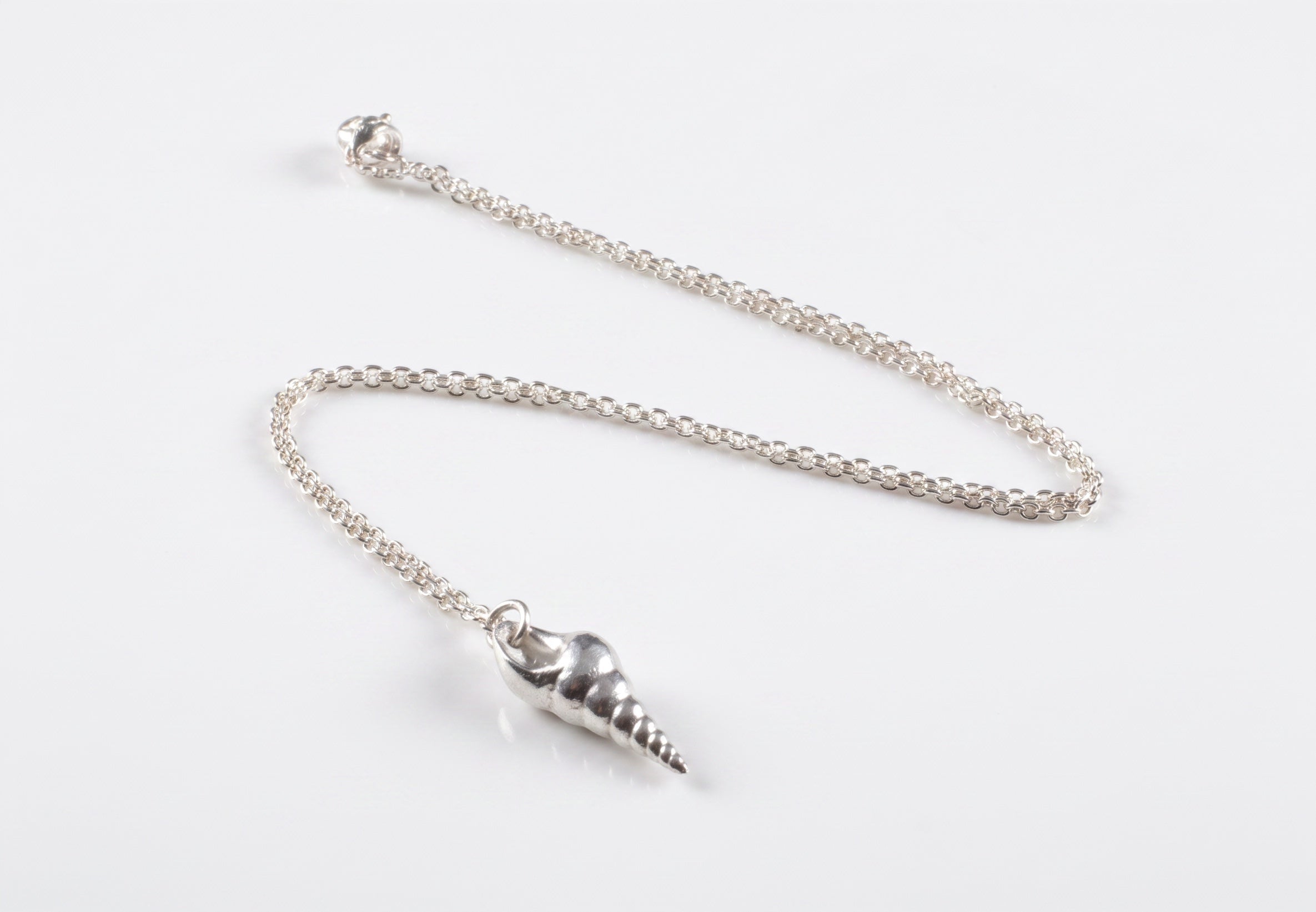 Blue Dragonfly Creations fine 999 silver seashell pendant on a delicate sterling silver chain with a polished finish.